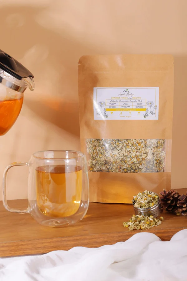 chamomile flowers tea being poured in glass cup lifestyle